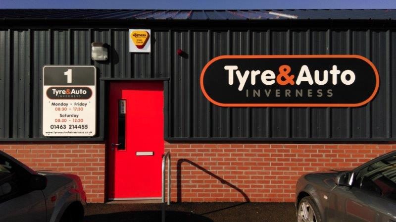 The Unit 1 door and the Tyre&Auto Inverness sign with opening hours board