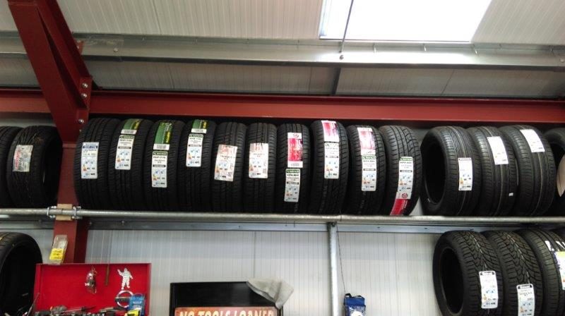 Racks of new tyres inside the Tyre&Auto workshop
